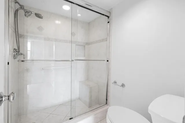 a view of pool with outdoor seating and city view