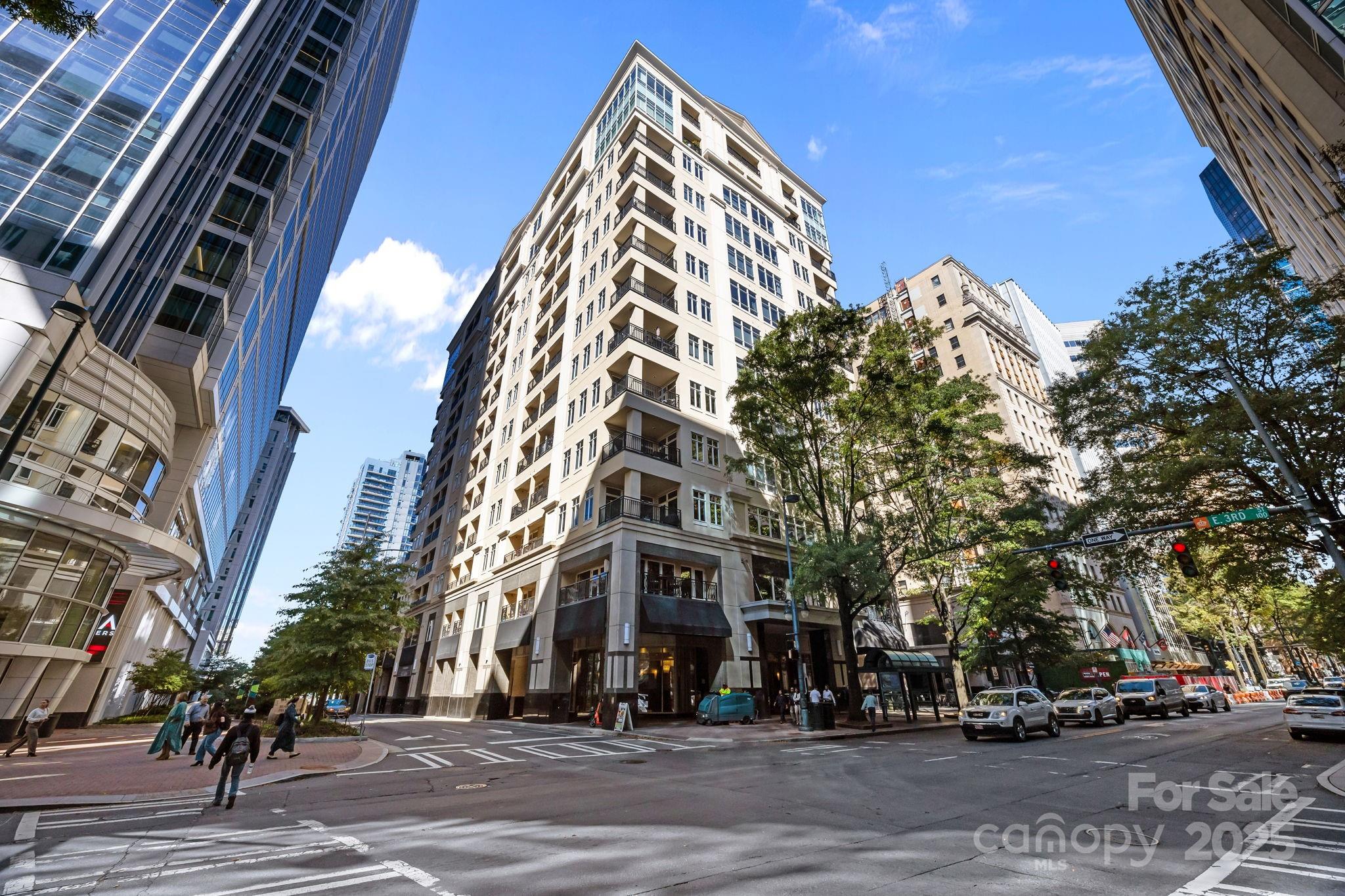 a view of a tall building next to a road