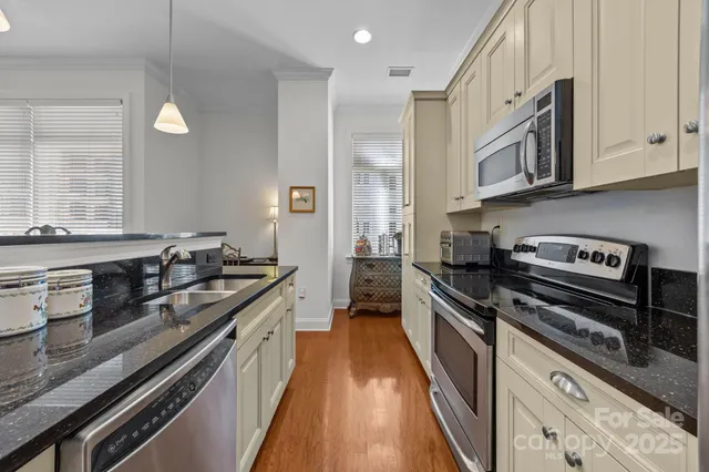 a kitchen with stainless steel appliances granite countertop a stove and a sink