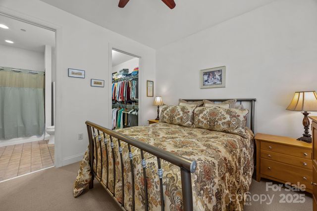 a bed room with furniture and painting on the wall