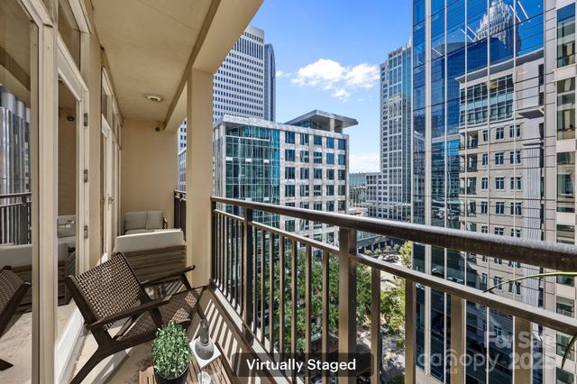 a view of a balcony with wooden chairs