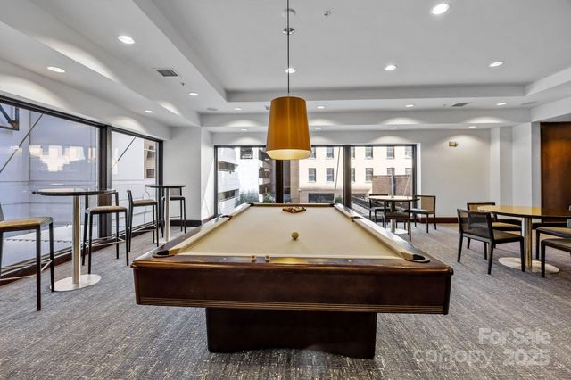 a room with table chairs and window