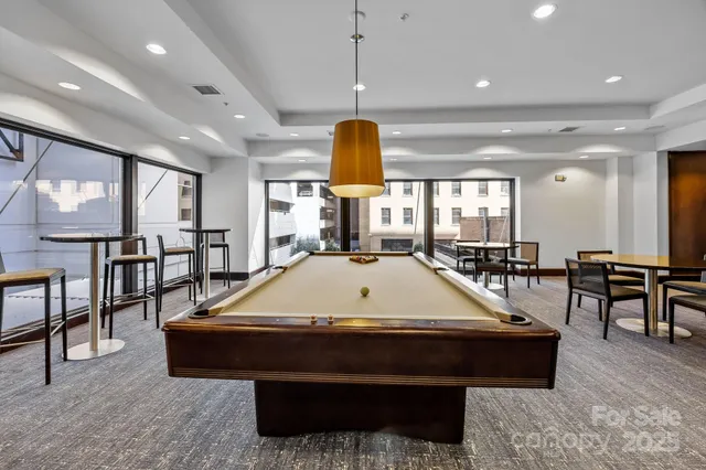 a room with table chairs and window