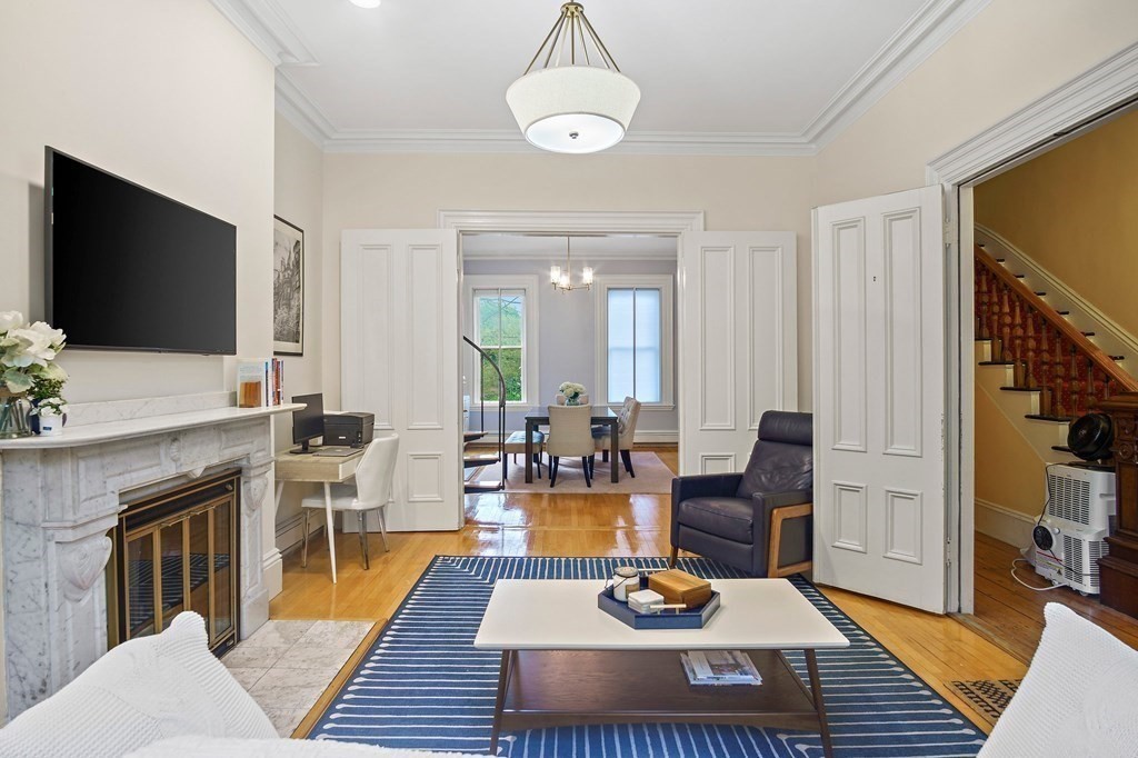 a living room with furniture a flat screen tv and kitchen view