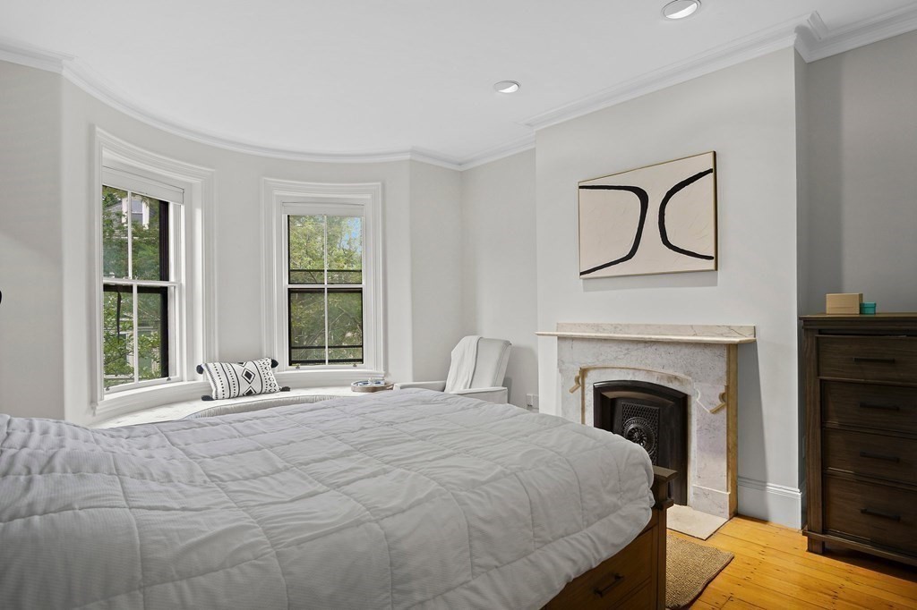 28 Everett Street, Unit 2 Boston, MA 02130 - Photo 16 of 25 a bedroom with a bed and a fireplace