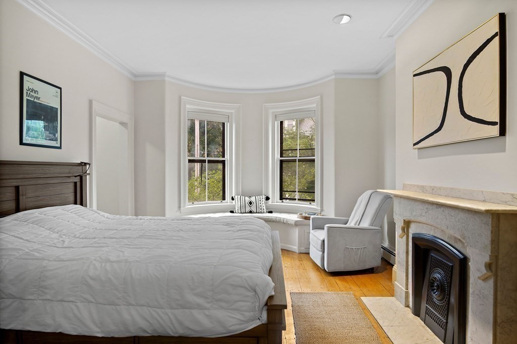 28 Everett Street, Unit 2 Boston, MA 02130 - Photo 17 of 25 a bedroom with furniture and a fireplace