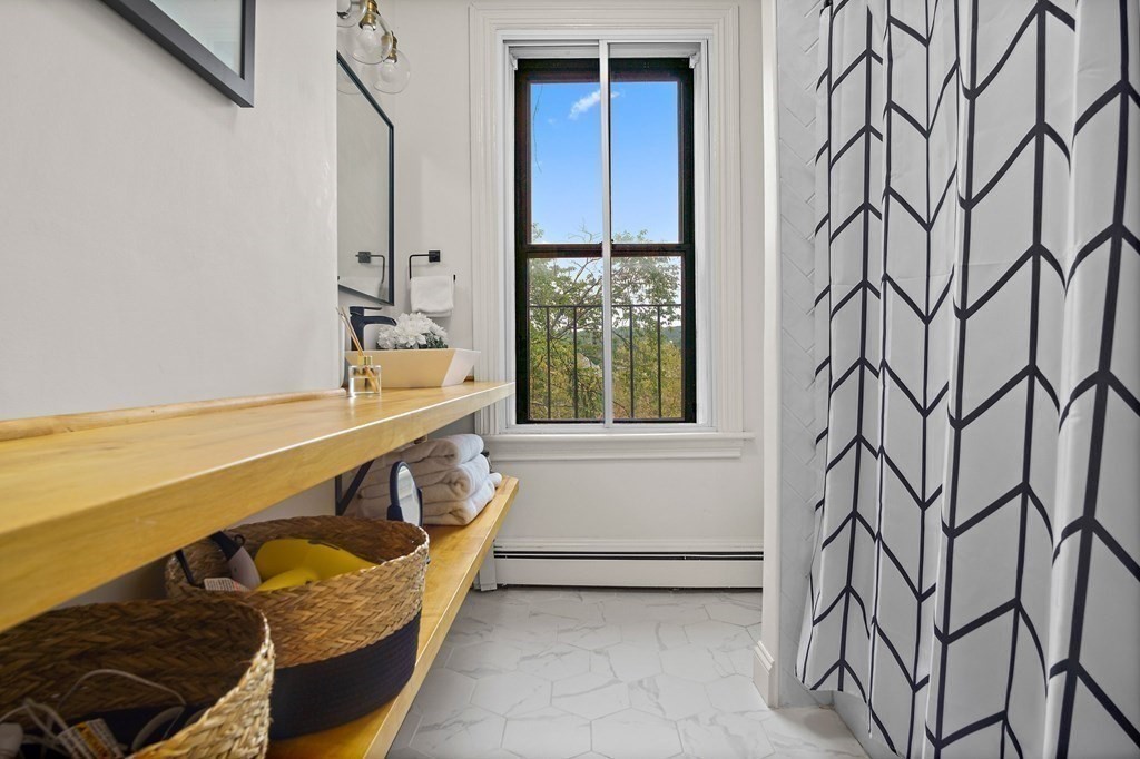 28 Everett Street, Unit 2 Boston, MA 02130 - Photo 20 of 25 a bathroom with a bathtub and window