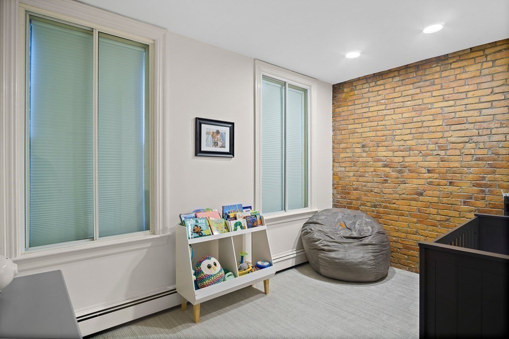 28 Everett Street, Unit 2 Boston, MA 02130 - Photo 24 of 25 a room with a couch and a potted plant