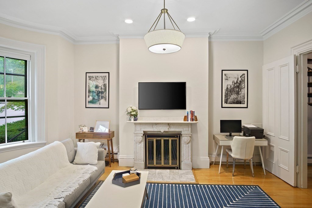28 Everett Street, Unit 2 Boston, MA 02130 - Photo 5 of 25 a living room with furniture a flat screen tv and a fireplace