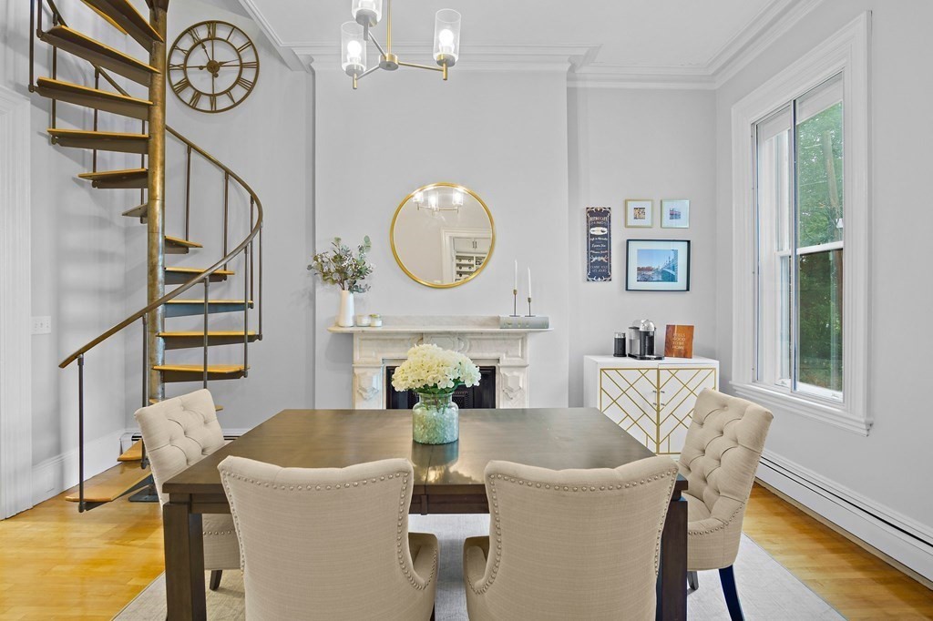 28 Everett Street, Unit 2 Boston, MA 02130 - Photo 9 of 25 a view of a dining room with furniture a chandelier and wooden floor
