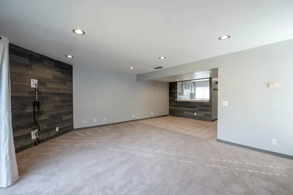 a view of an empty room with closet and cabinet