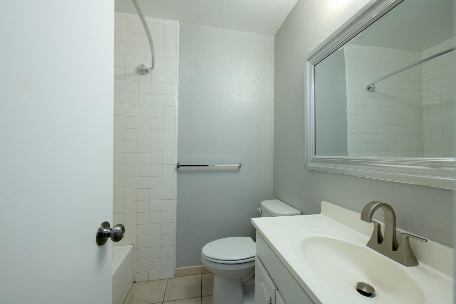 4875 North Backer Avenue, Unit 141 Fresno, CA 93726 - Photo 11 of 23 a bathroom with a sink toilet and a mirror