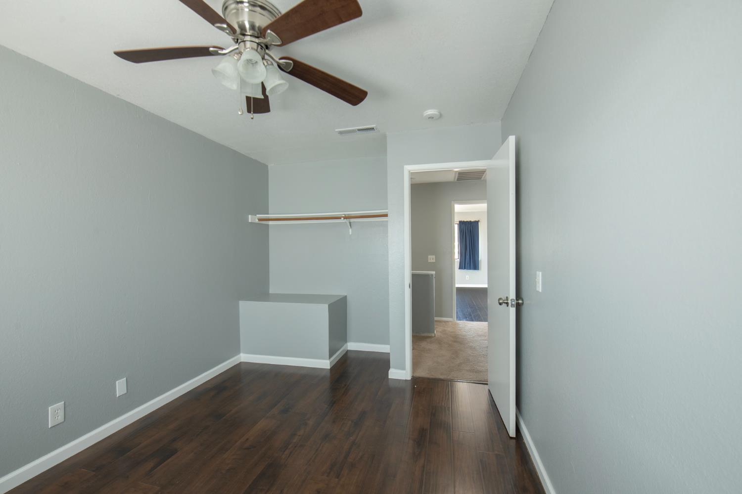 4875 North Backer Avenue, Unit 141 Fresno, CA 93726 - Photo 13 of 23 wooden floor in an empty room with a window