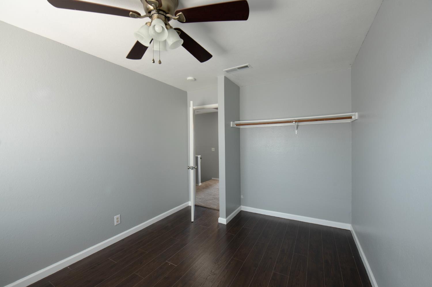 4875 North Backer Avenue, Unit 141 Fresno, CA 93726 - Photo 14 of 23 an empty room with wooden floor closet and windows