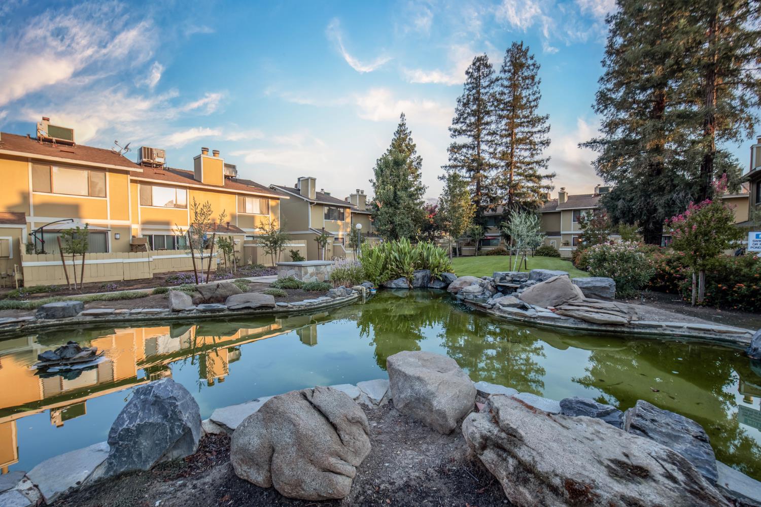 4875 North Backer Avenue, Unit 141 Fresno, CA 93726 - Photo 22 of 23 a view of a swimming pool and a lounge chair