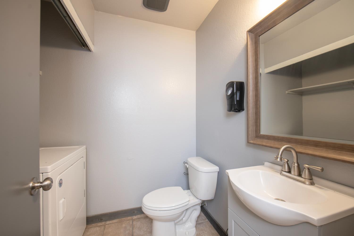 4875 North Backer Avenue, Unit 141 Fresno, CA 93726 - Photo 4 of 23 a bathroom with a sink toilet and mirror