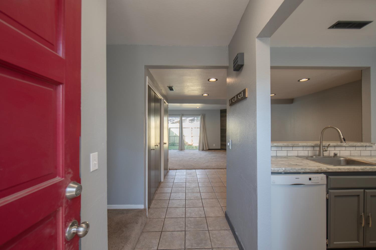4875 North Backer Avenue, Unit 141 Fresno, CA 93726 - Photo 6 of 23 a view of a hallway with a kitchen