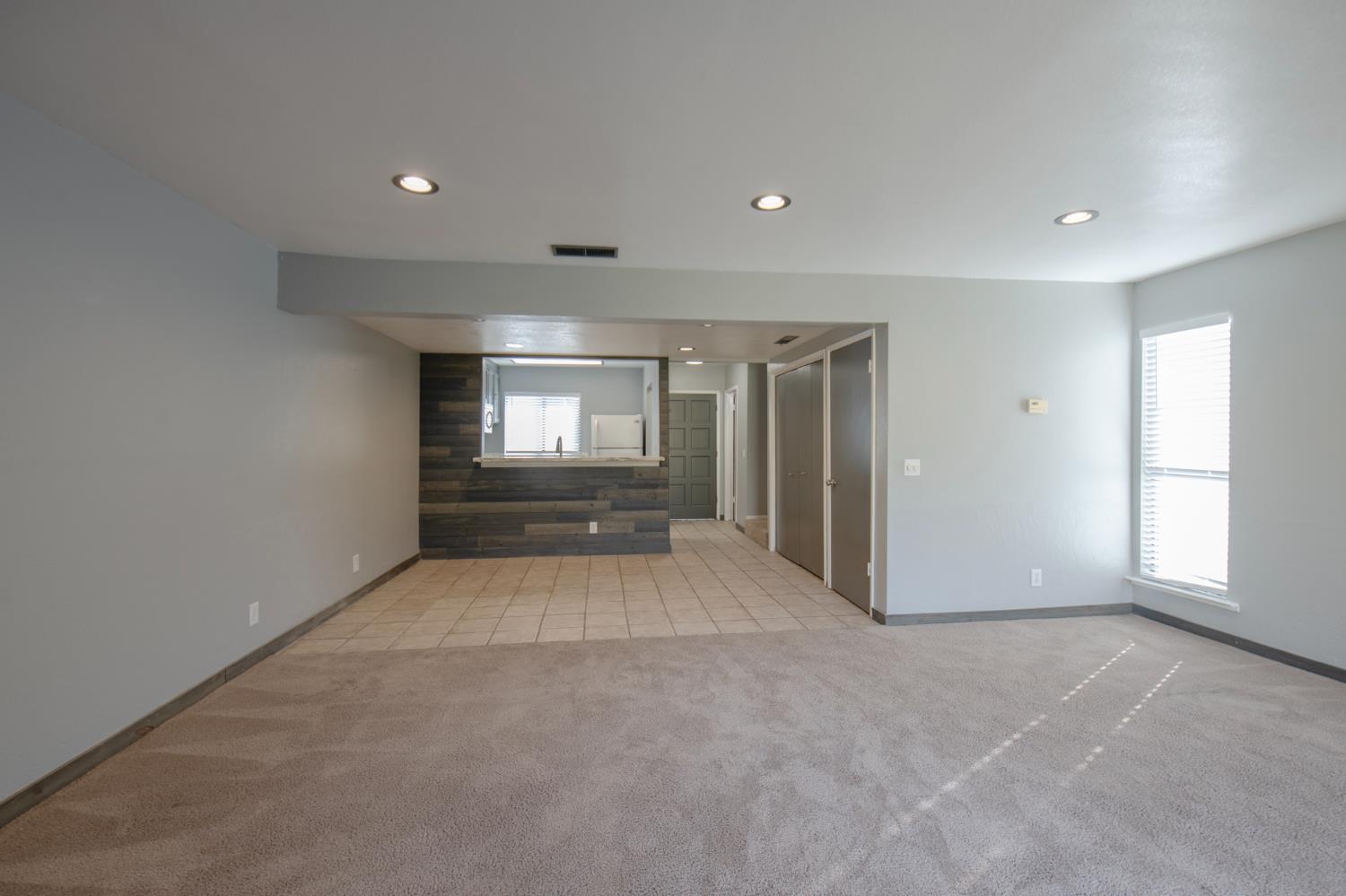 4875 North Backer Avenue, Unit 141 Fresno, CA 93726 - Photo 9 of 23 an empty room with windows and ceiling fan