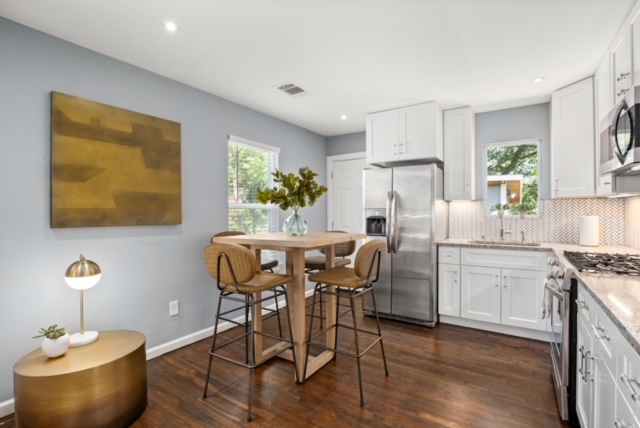 1183 Coleto Street Austin, TX 78702 - Photo 11 of 17 a kitchen with a table chairs refrigerator and cabinets