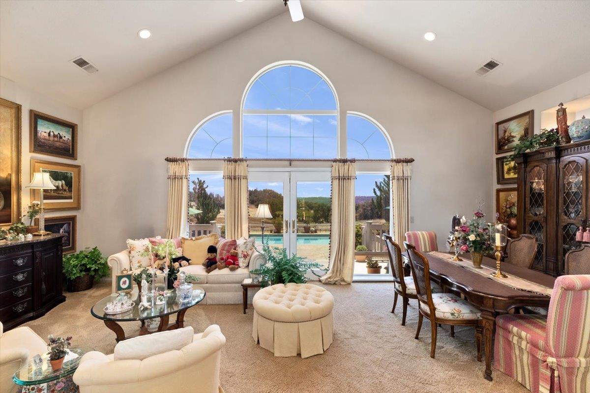 4558 Country View Court Cool, CA 95614 - Photo 20 of 82 a living room with furniture a fireplace and a large window