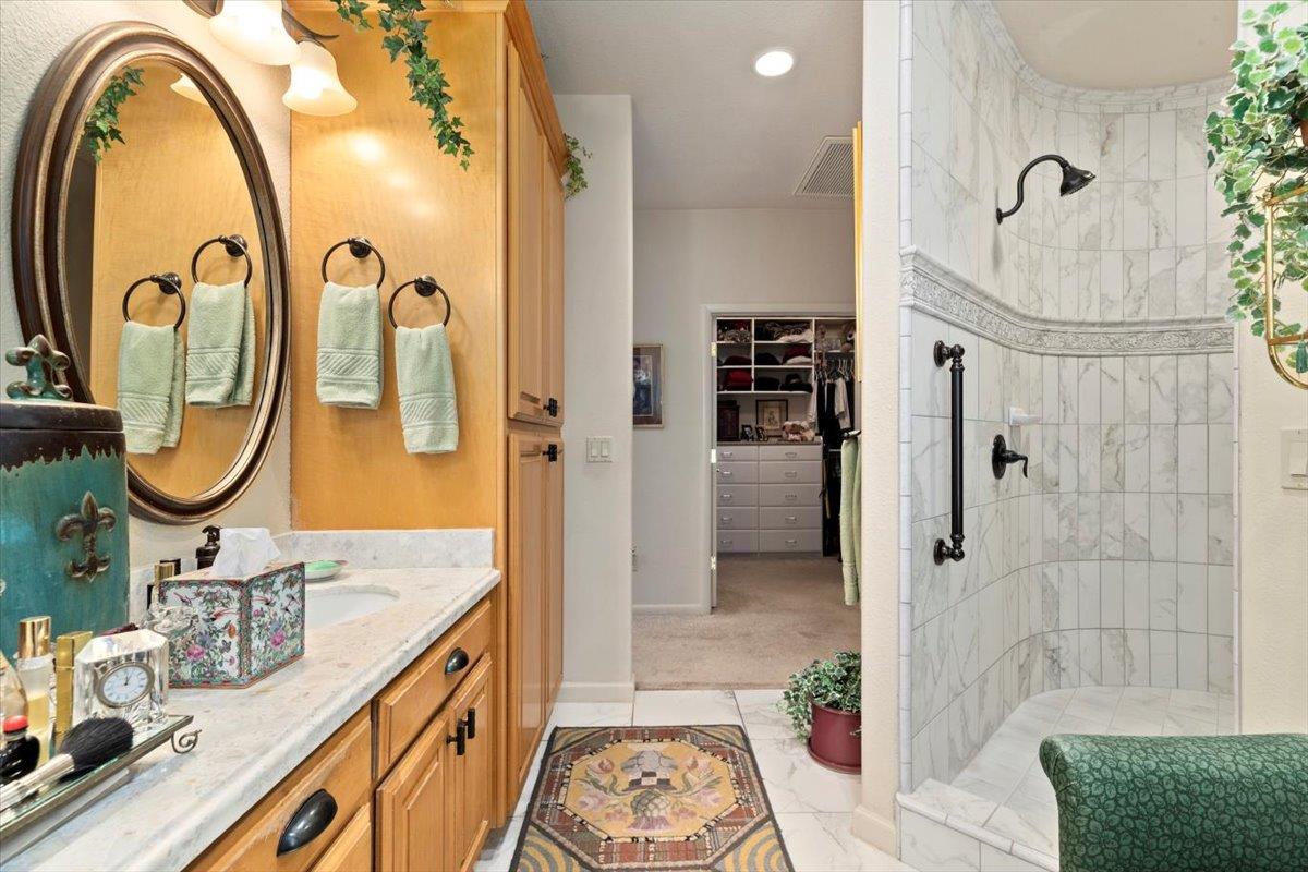4558 Country View Court Cool, CA 95614 - Photo 41 of 82 a bathroom with a granite countertop sink a mirror and shower