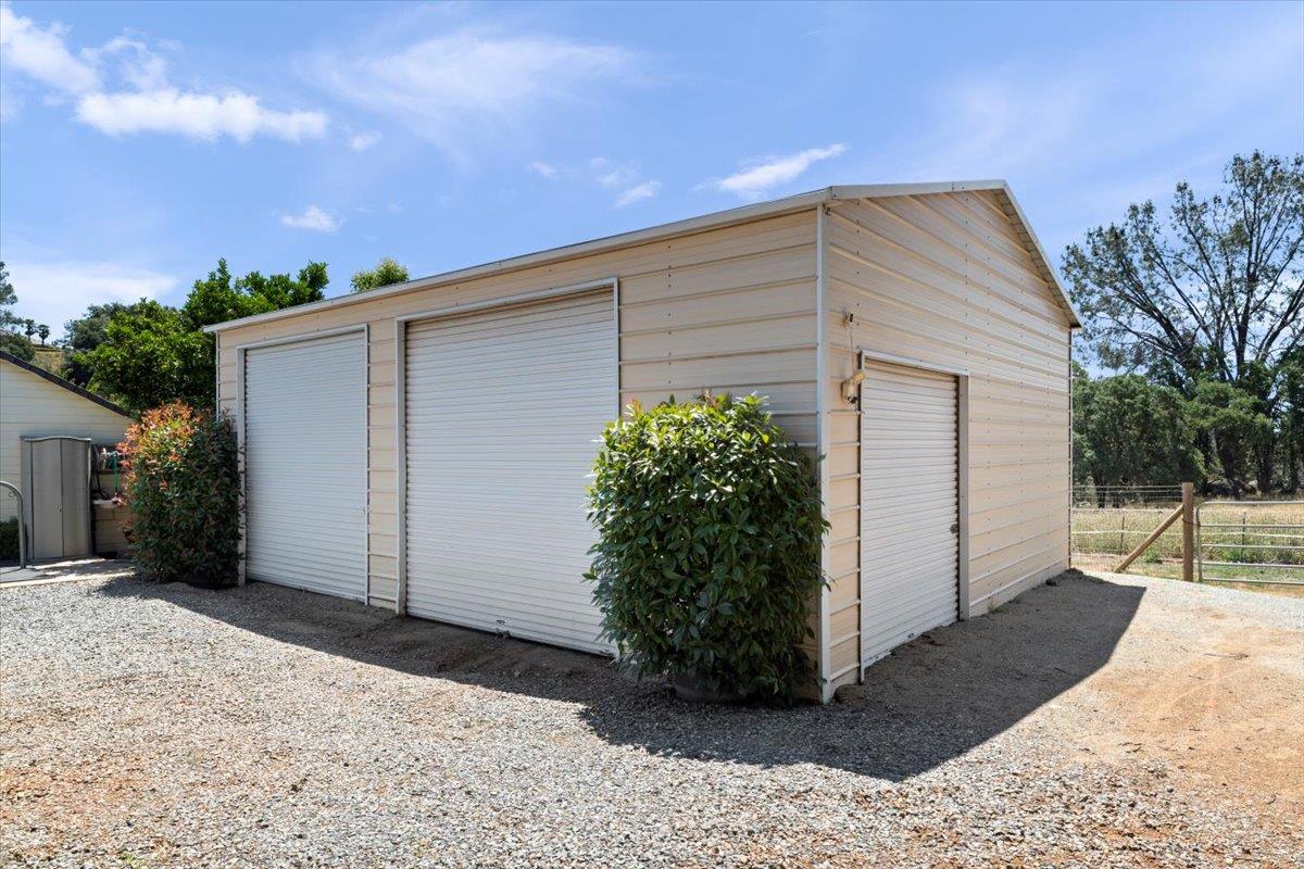 4558 Country View Court Cool, CA 95614 - Photo 54 of 82 a backyard of a house with potted plants and garage