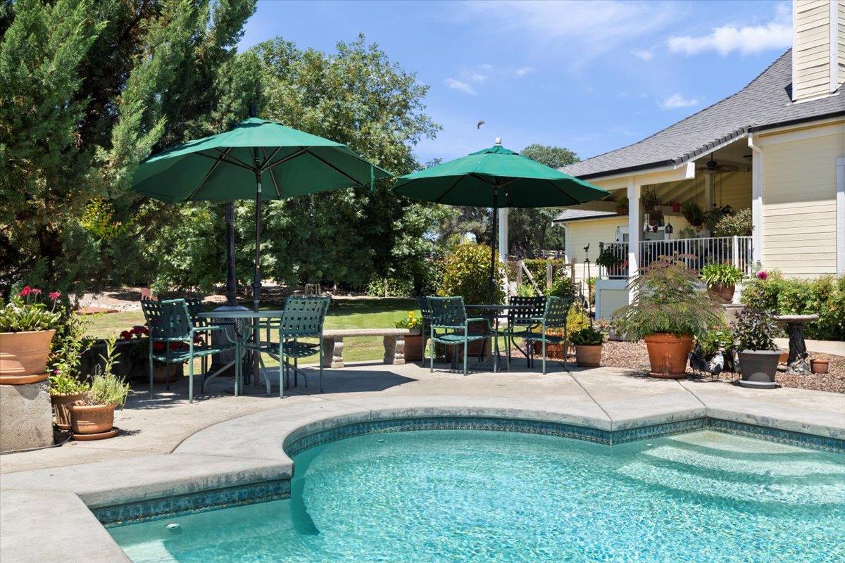 4558 Country View Court Cool, CA 95614 - Photo 57 of 82 a view of a patio with a table and chairs under an umbrella