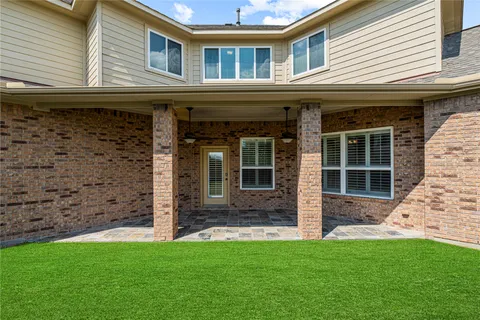a view of a house with a large window and a yard