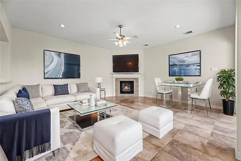 a living room with furniture a fireplace and a flat screen tv