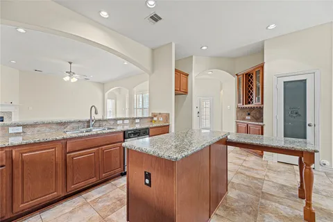 a bathroom with a granite countertop double vanity sink and a mirror