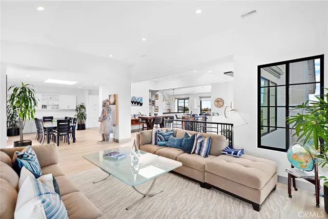 a kitchen with stainless steel appliances kitchen island granite countertop a table and chairs in it