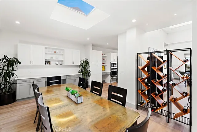a view of a patio with couches dining table and chairs with wooden floor
