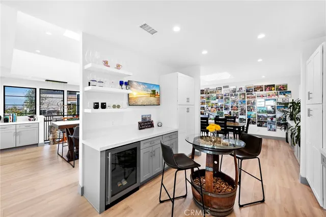 a dining hall with stainless steel appliances a table and chairs