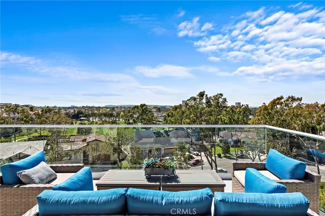 a view of a patio with couches dining table and chairs with wooden floor