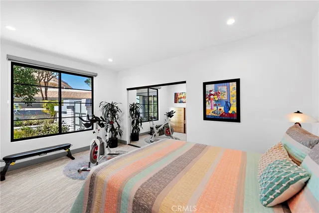 a view of a bedroom with furniture and closet