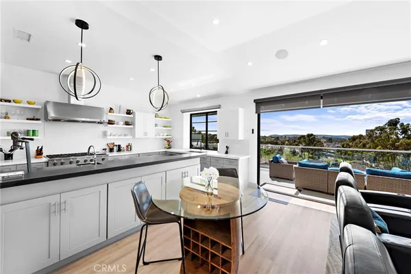 a dining hall with stainless steel appliances a table and chairs