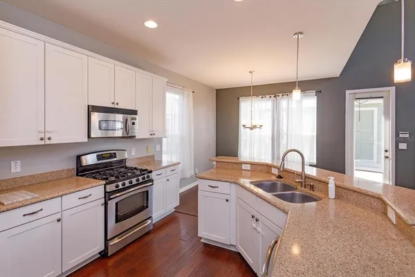 a kitchen that has a sink and a stove