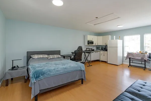 a bedroom with furniture and a large window