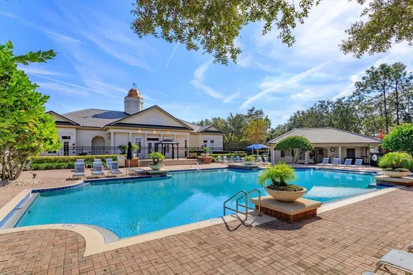 a front view of a house with swimming pool garden and patio