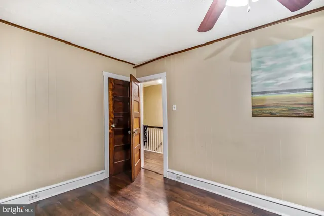 a view of an empty room with wooden floor