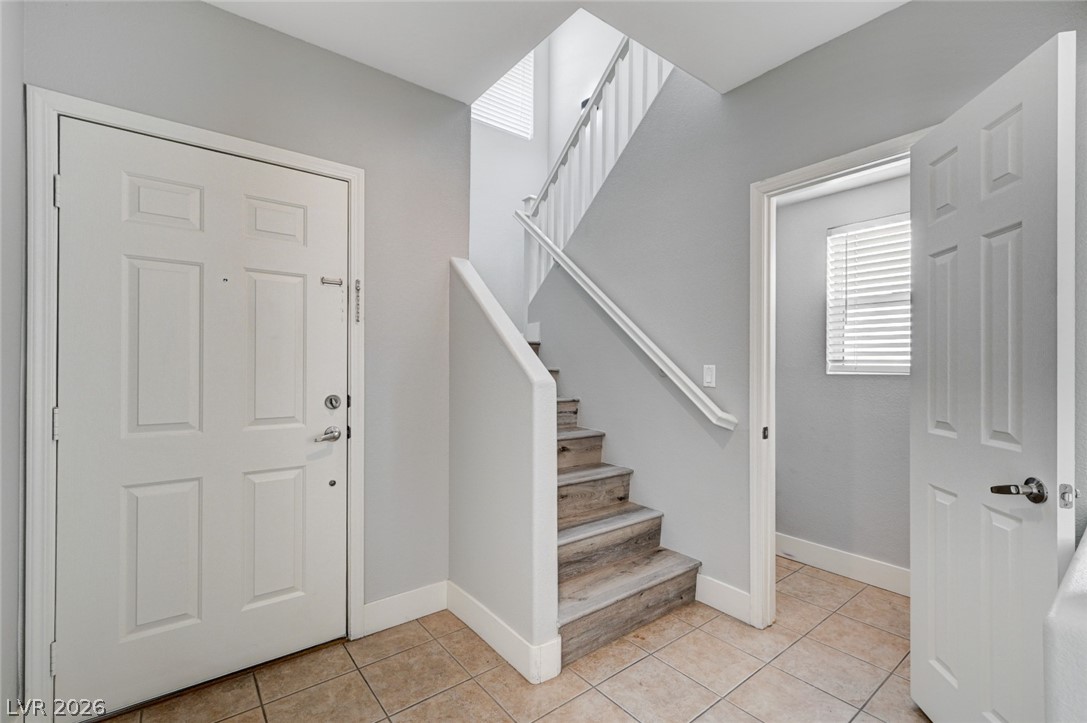 7259 Cestrum Road Las Vegas, NV 89113 - Photo 5 of 35 A welcoming entry features a striking staircase with wood treads and natural light from above.