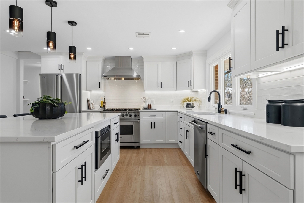 171 Shaw Road Brookline, MA 02467 - Photo 4 of 42 a kitchen with a sink stove and cabinets