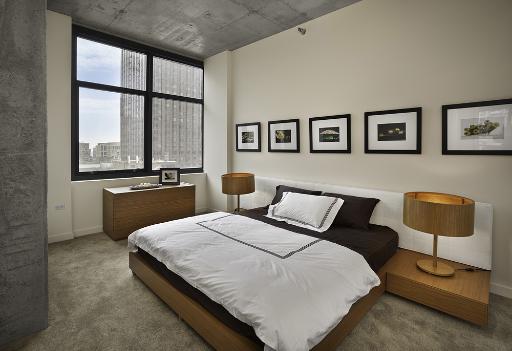 235 West Van Buren Street, Unit 2601 Chicago, IL 60607 - Photo 5 of 11 a bedroom with a bed and a window