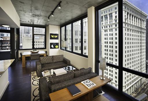 235 West Van Buren Street, Unit 2601 Chicago, IL 60607 - Photo 7 of 11 a living room with furniture and a floor to ceiling window