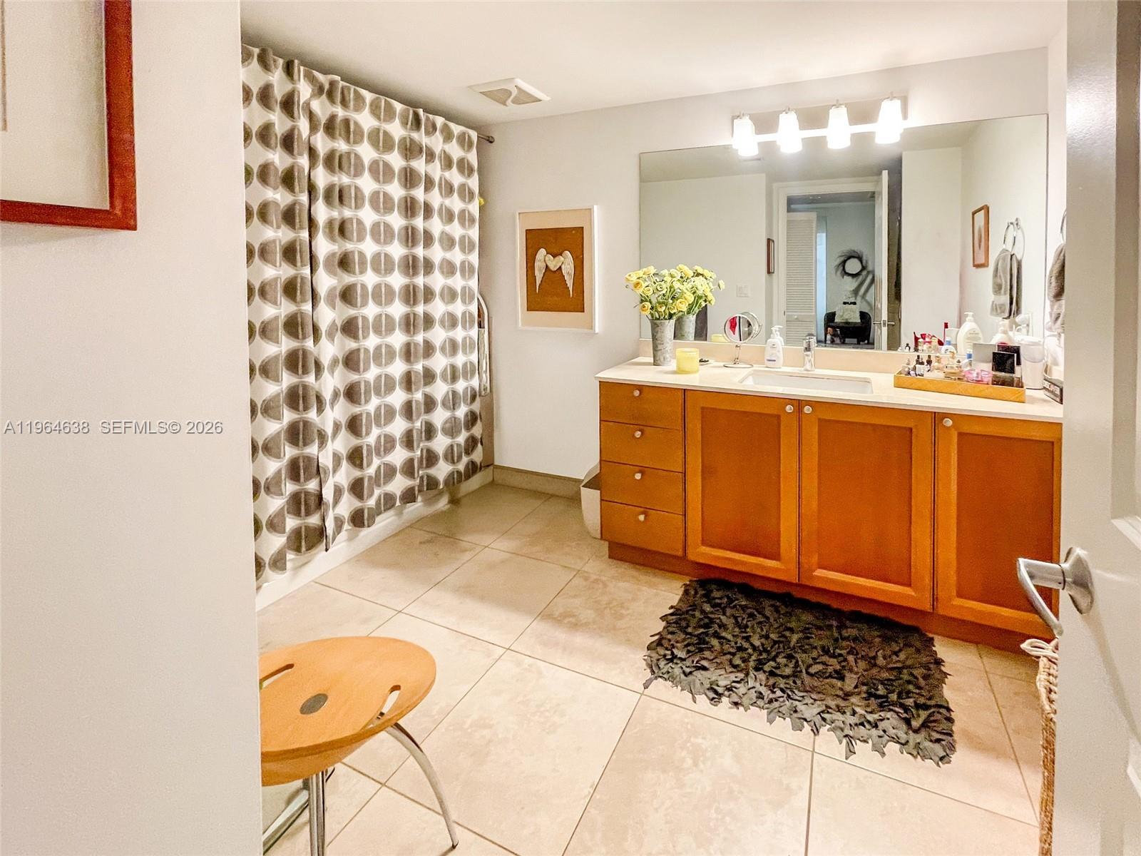 55 Merrick Way, Unit 715 Coral Gables, FL 33134 - Photo 12 of 52 a bathroom with a double vanity sink mirror and shower