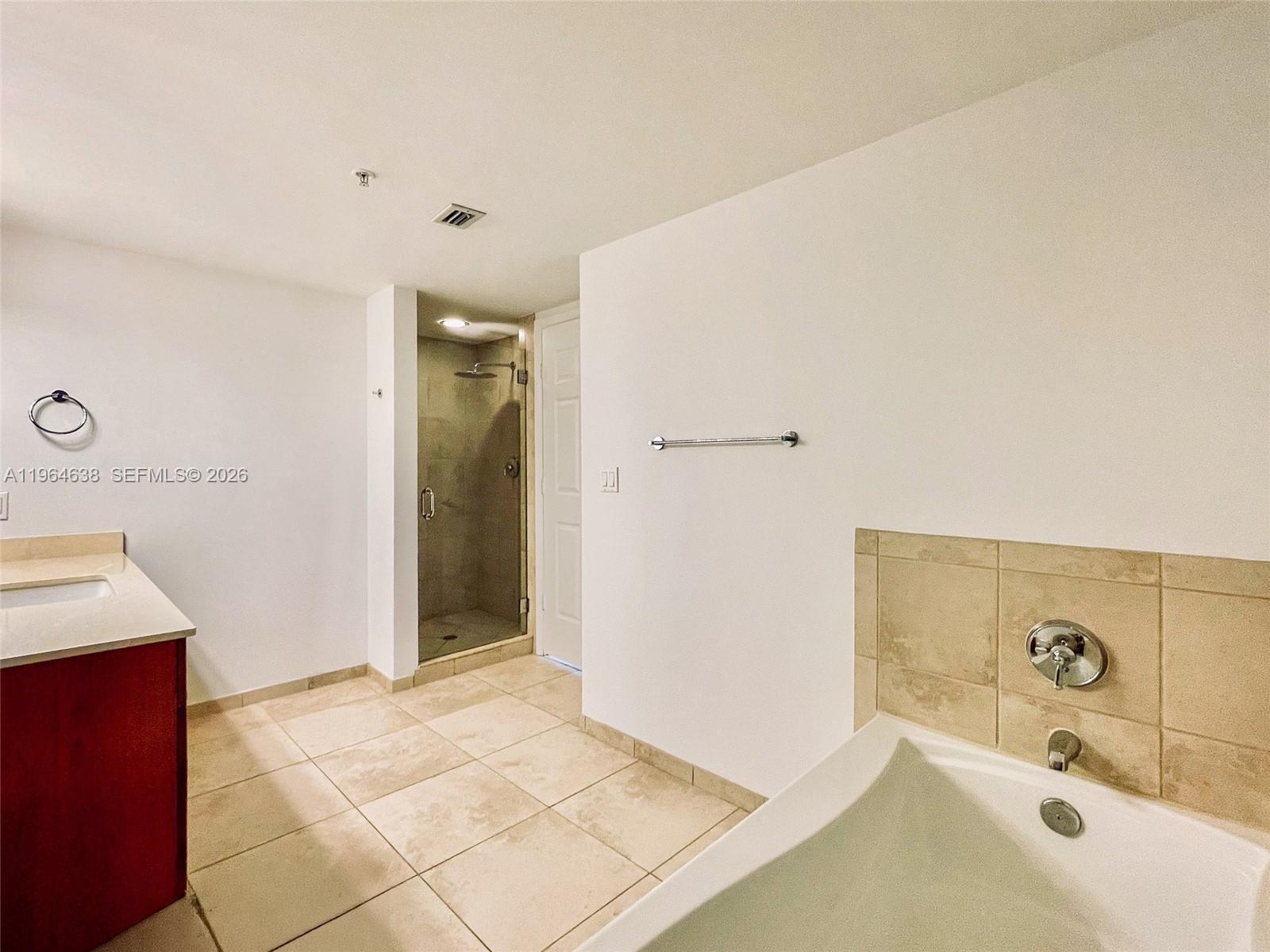 55 Merrick Way, Unit 715 Coral Gables, FL 33134 - Photo 13 of 52 a bathroom with a tub sink and mirror