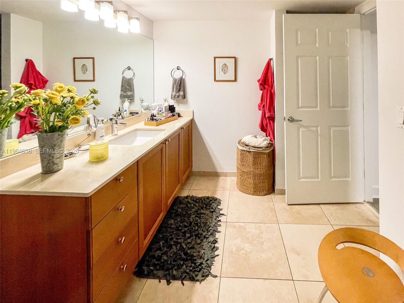 55 Merrick Way, Unit 715 Coral Gables, FL 33134 - Photo 14 of 52 a bathroom with a sink mirror and vanity