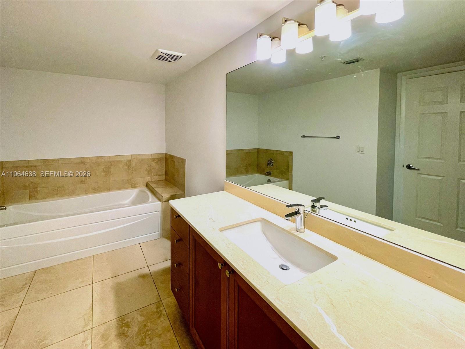 55 Merrick Way, Unit 715 Coral Gables, FL 33134 - Photo 17 of 52 a bathroom with a sink and a mirror