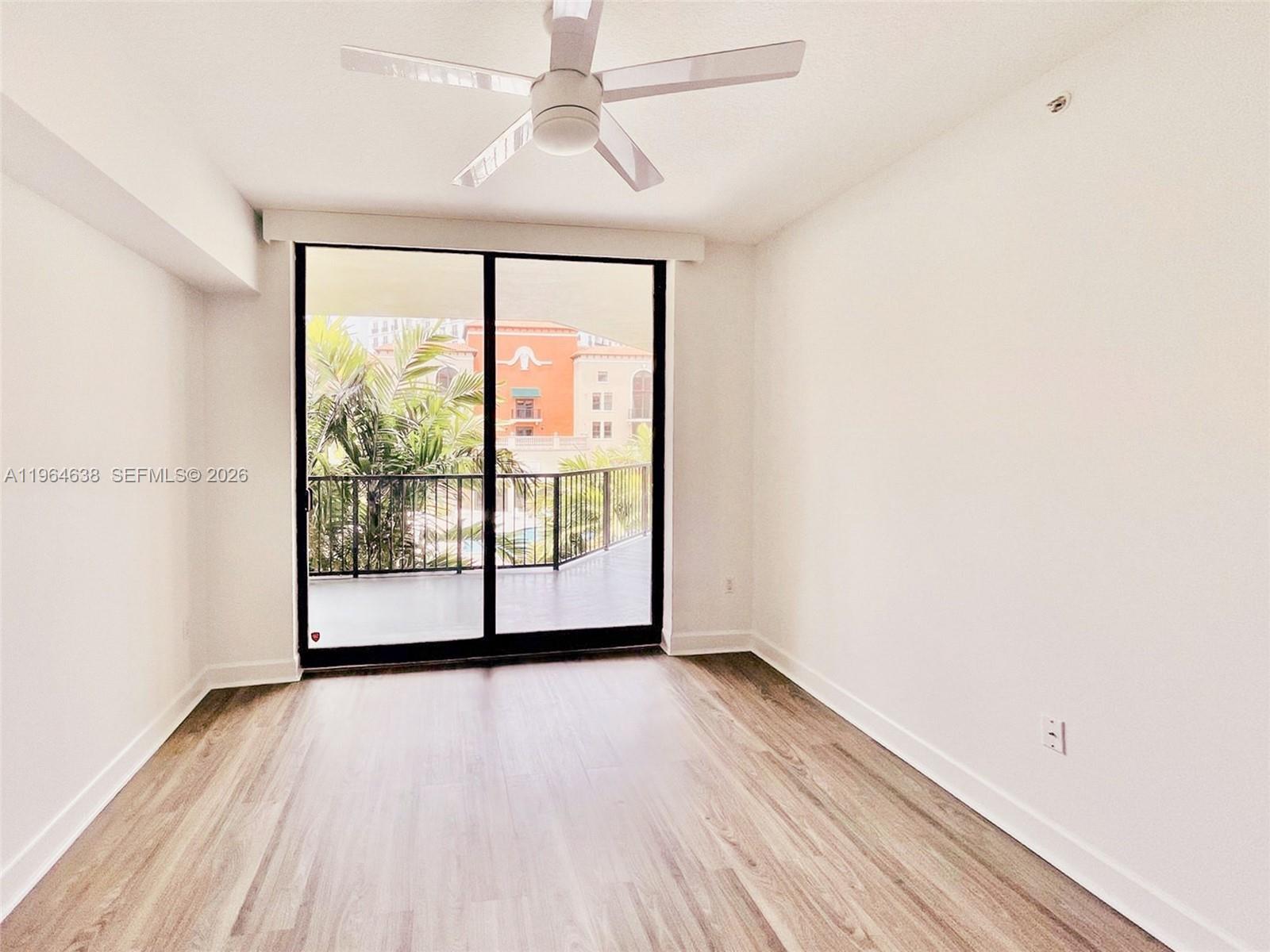 55 Merrick Way, Unit 715 Coral Gables, FL 33134 - Photo 19 of 52 a view of a room with wooden floor and a window