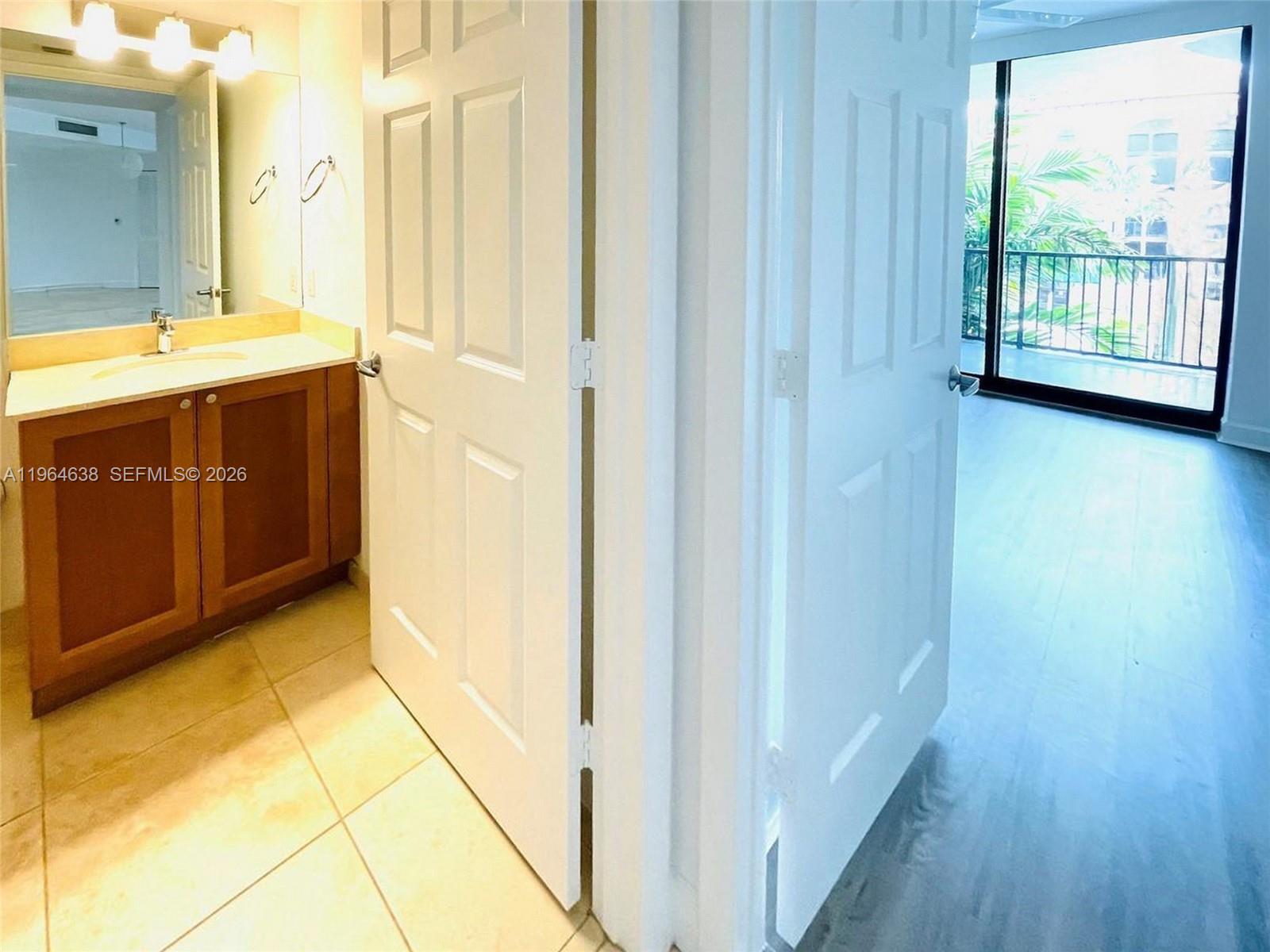 55 Merrick Way, Unit 715 Coral Gables, FL 33134 - Photo 24 of 52 a bathroom with a granite countertop sink and a mirror